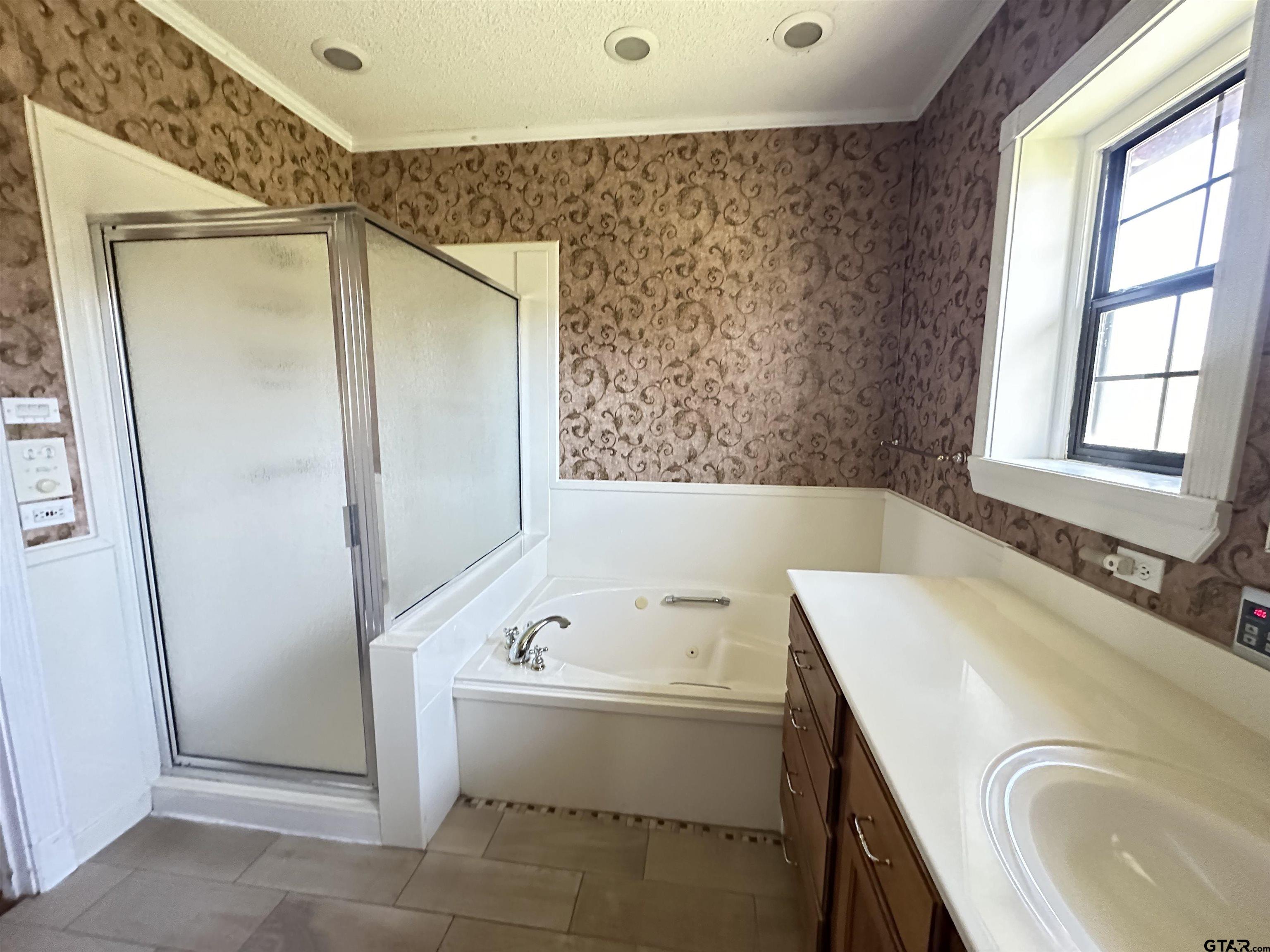 2337 East Rusk Street Jacksonville, TX 75766 - Photo 27 of 47 a bathroom with a tub sink and mirror
