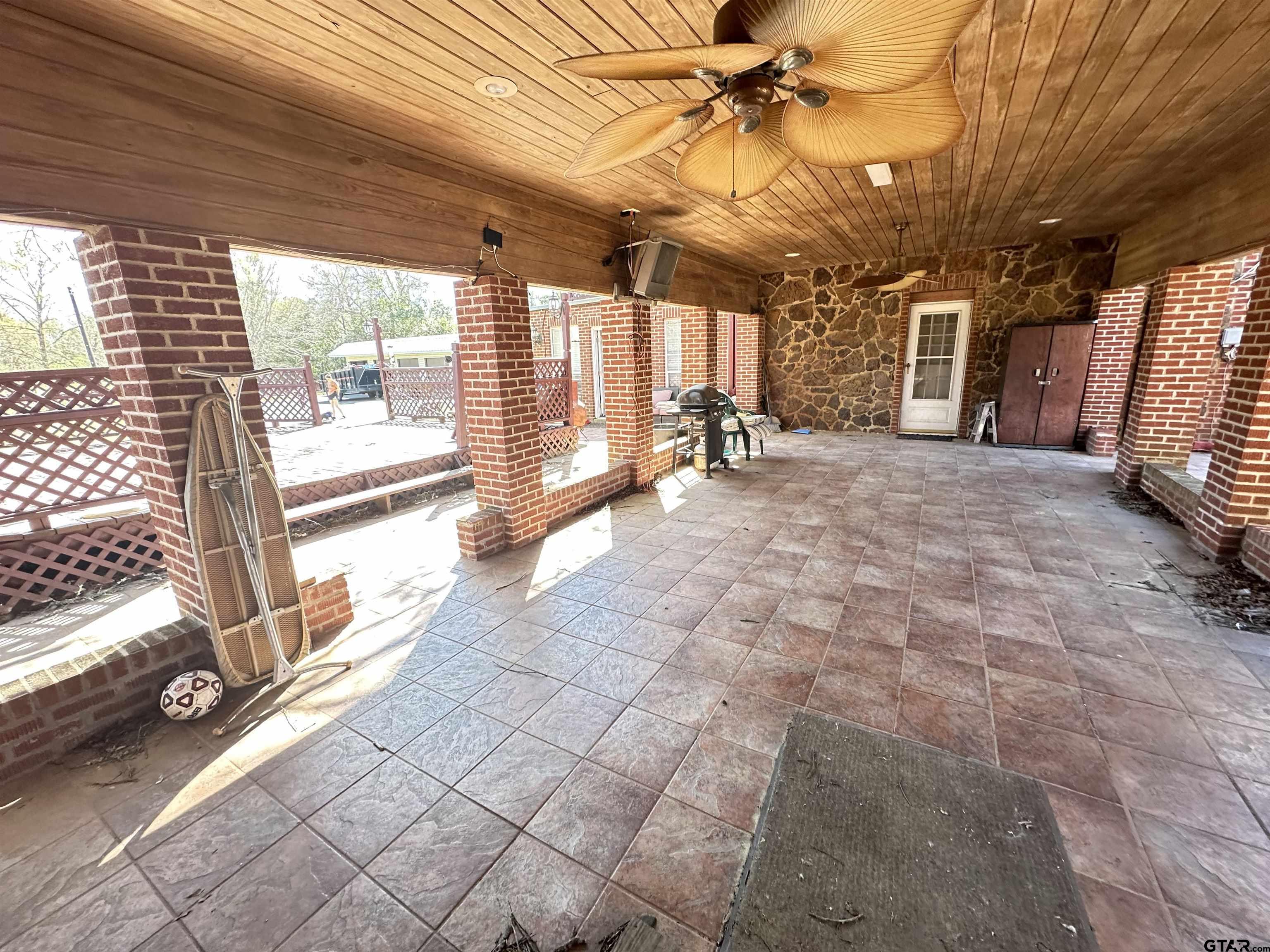 2337 East Rusk Street Jacksonville, TX 75766 - Photo 31 of 47 a view of a porch with furniture and a backyard