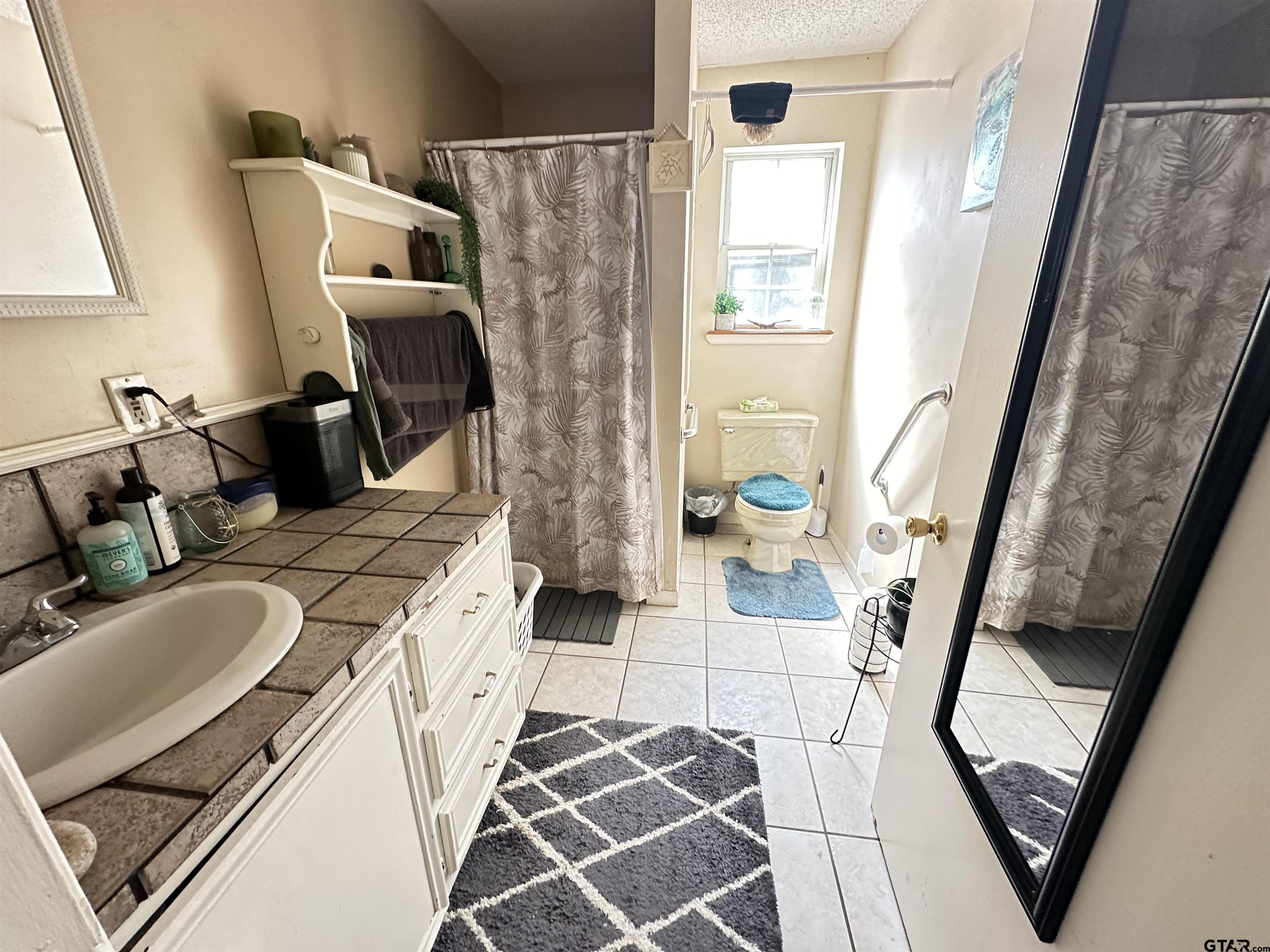 2337 East Rusk Street Jacksonville, TX 75766 - Photo 40 of 47 a living room with furniture and a fireplace