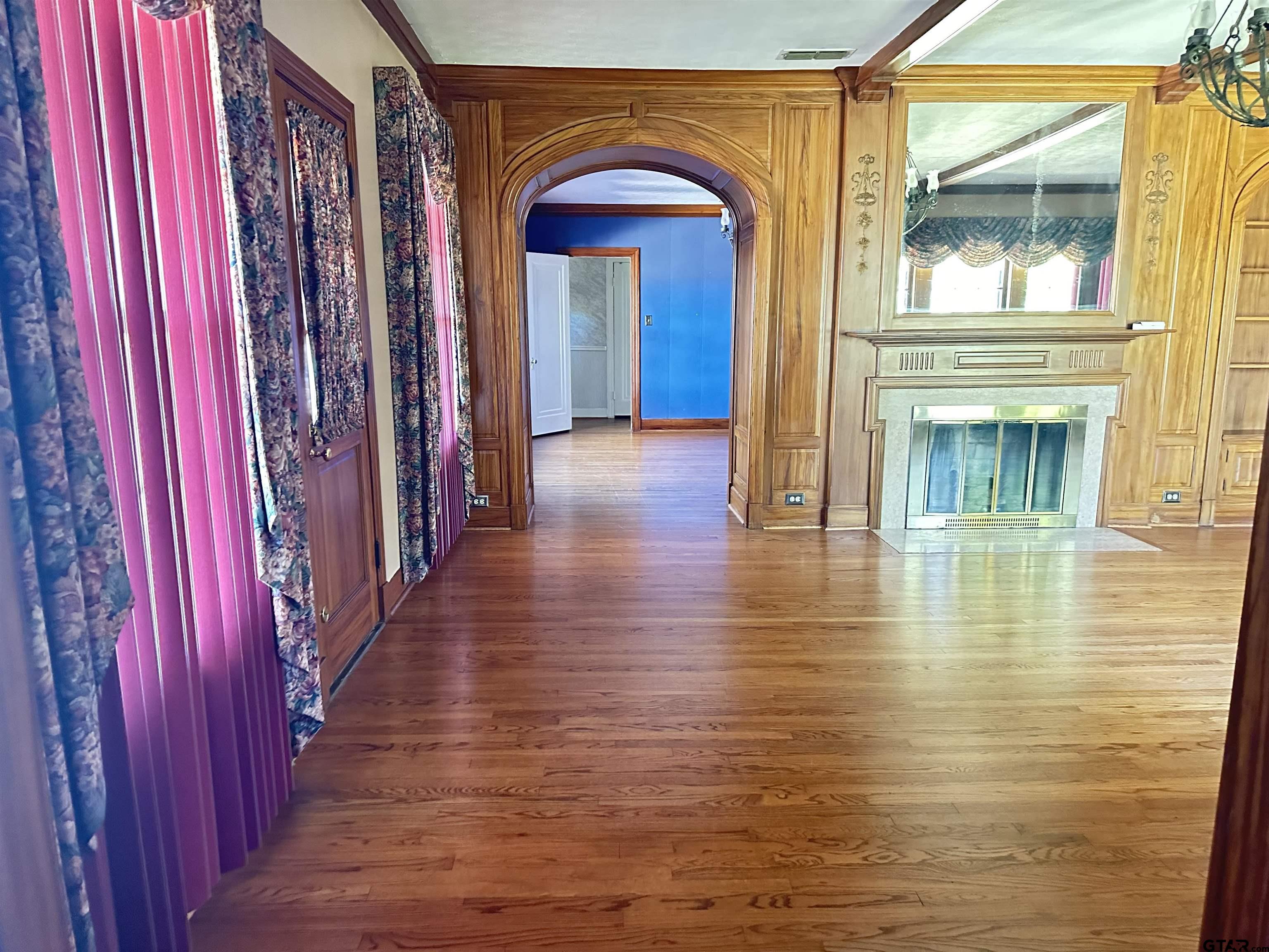 2337 East Rusk Street Jacksonville, TX 75766 - Photo 4 of 47 a view of a hallway with wooden floor and staircase