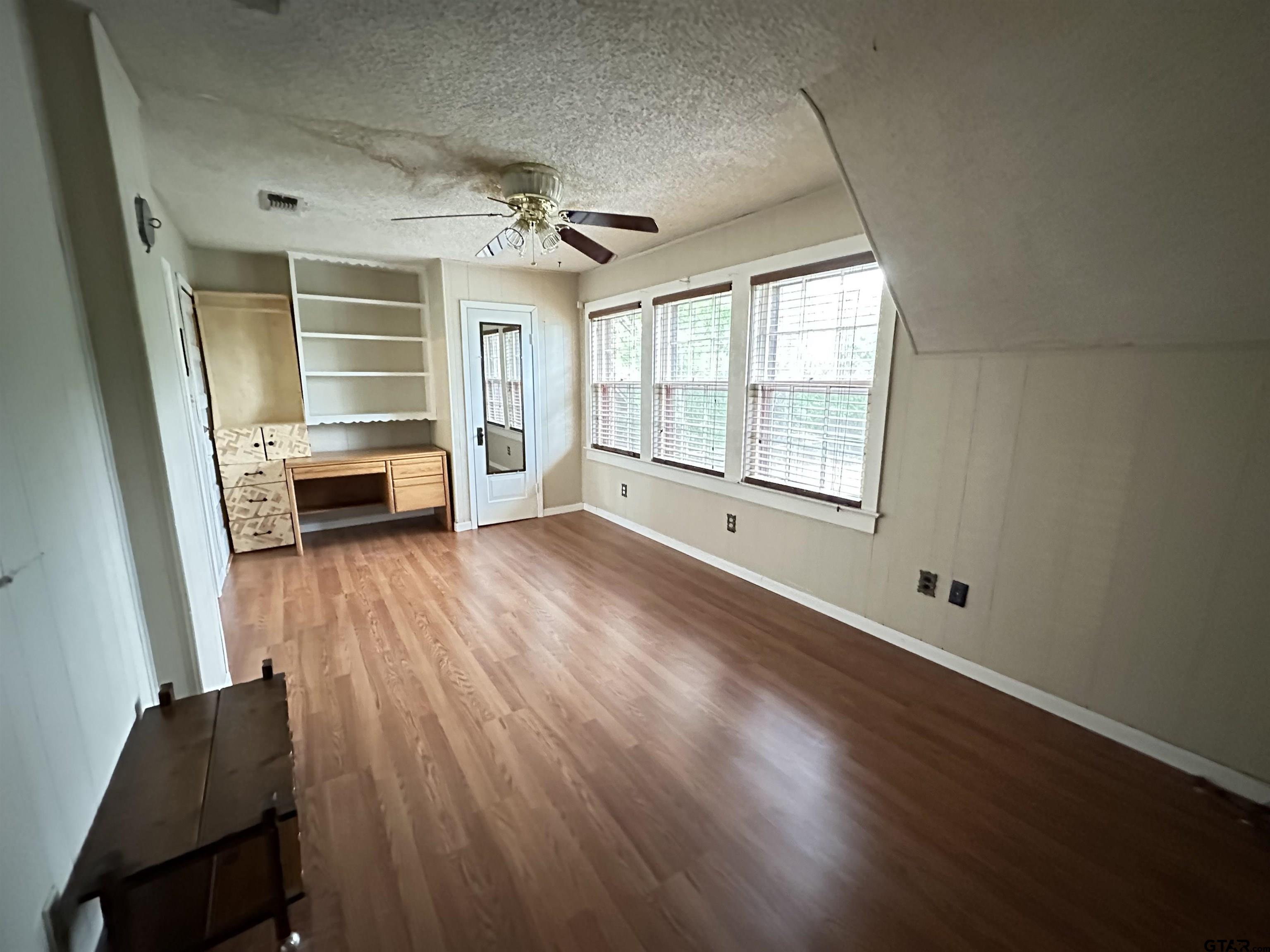 2337 East Rusk Street Jacksonville, TX 75766 - Photo 44 of 47 a view of empty room with wooden floor and fan