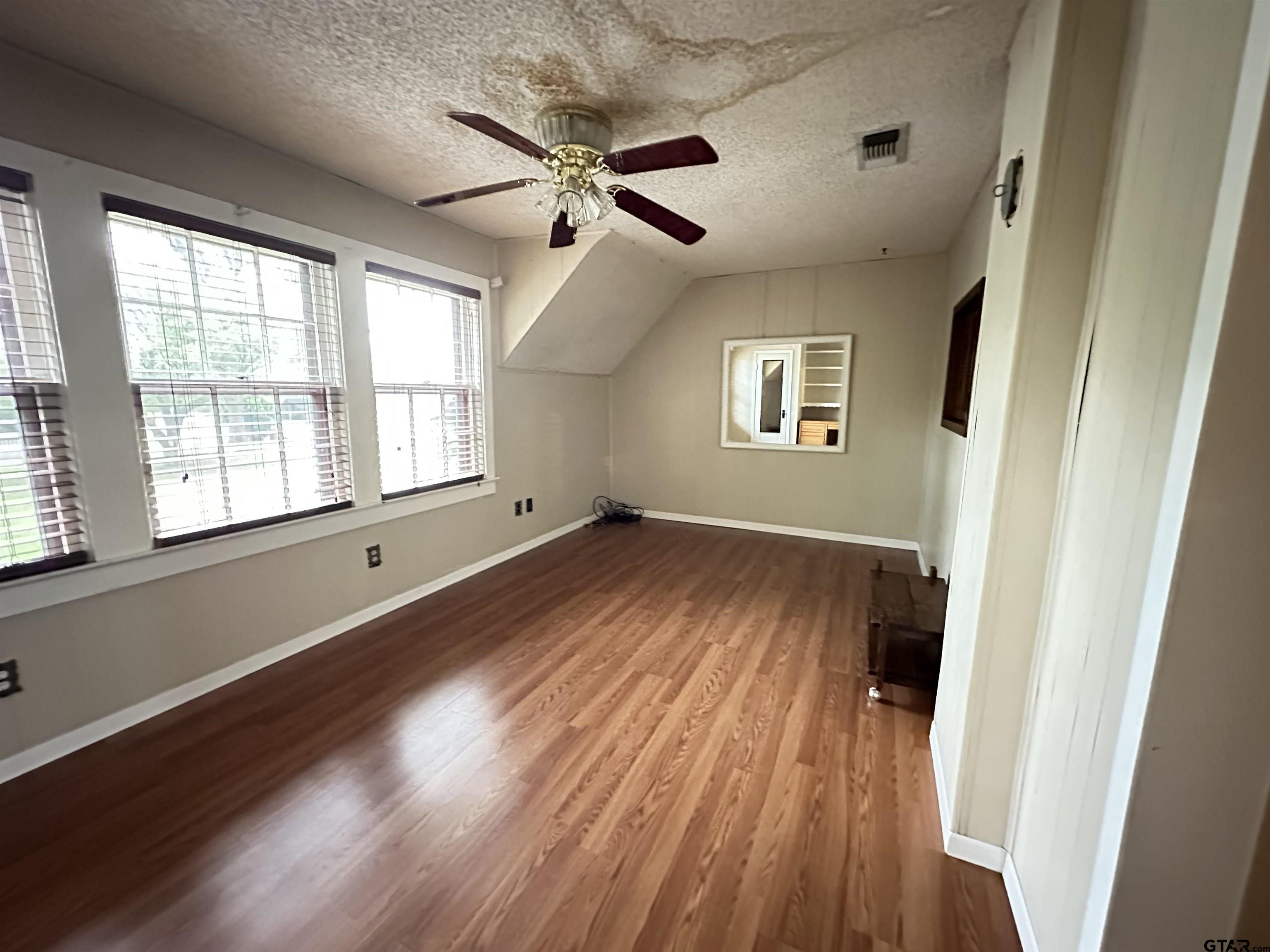 2337 East Rusk Street Jacksonville, TX 75766 - Photo 46 of 47 a view of an empty room with wooden floor and a window