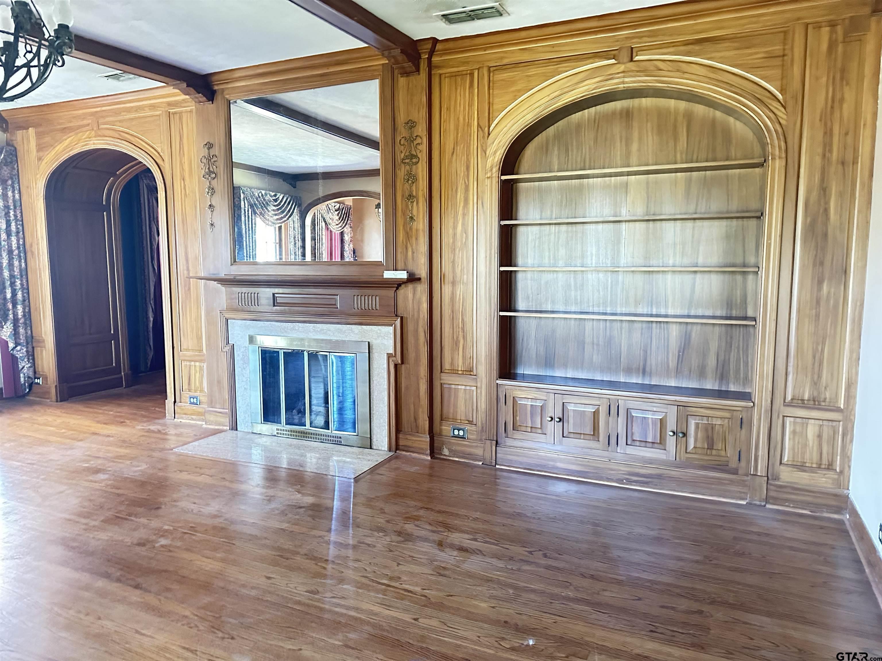 2337 East Rusk Street Jacksonville, TX 75766 - Photo 6 of 47 wooden floor view of an empty room with wooden floor and a window