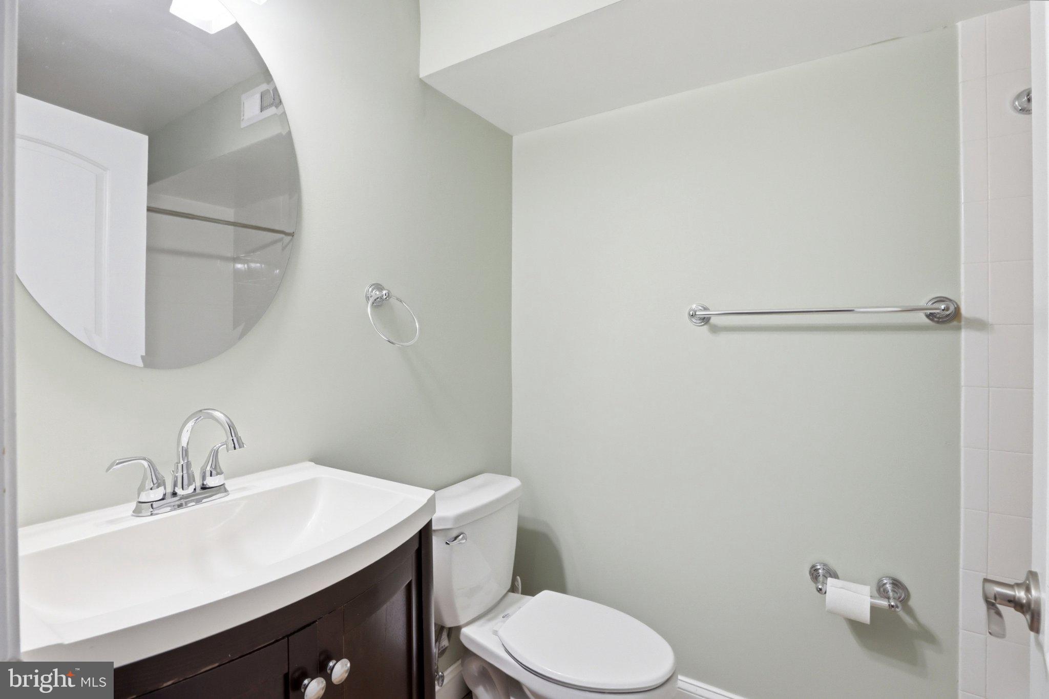 222 South Exeter Street Baltimore, MD 21202 - Photo 27 of 41 a bathroom with a toilet a sink and mirror