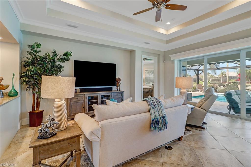 6487 Warwick Avenue Naples, FL 34113 - Photo 15 of 32 a living room with furniture and a flat screen tv