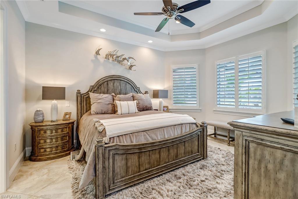 6487 Warwick Avenue Naples, FL 34113 - Photo 18 of 32 a bedroom with a bed dresser and a window