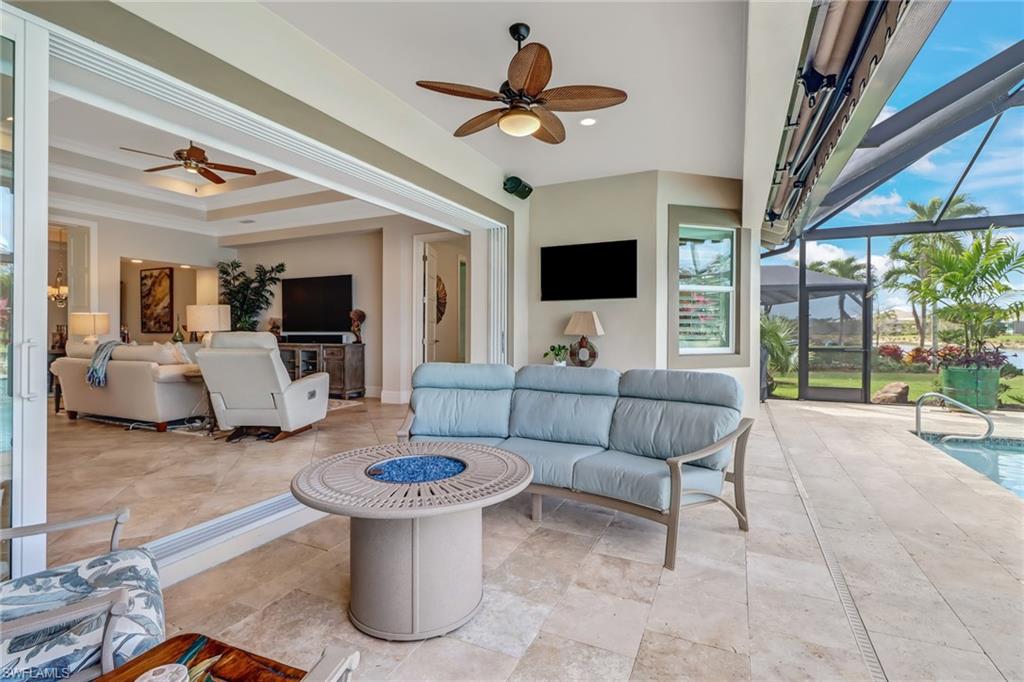 6487 Warwick Avenue Naples, FL 34113 - Photo 25 of 32 a living room with furniture and a flat screen tv