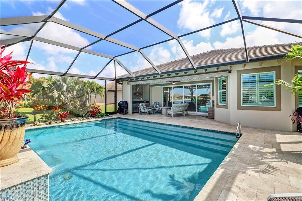 6487 Warwick Avenue Naples, FL 34113 - Photo 29 of 32 a view of a swimming pool with a patio