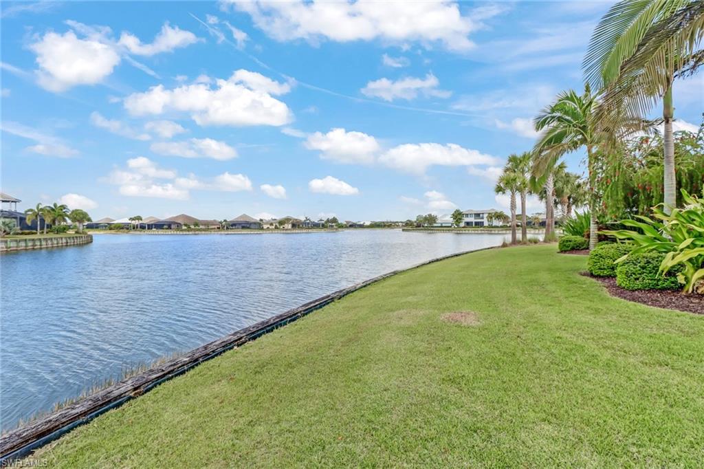 6487 Warwick Avenue Naples, FL 34113 - Photo 31 of 32 a view of a lake with houses in the back