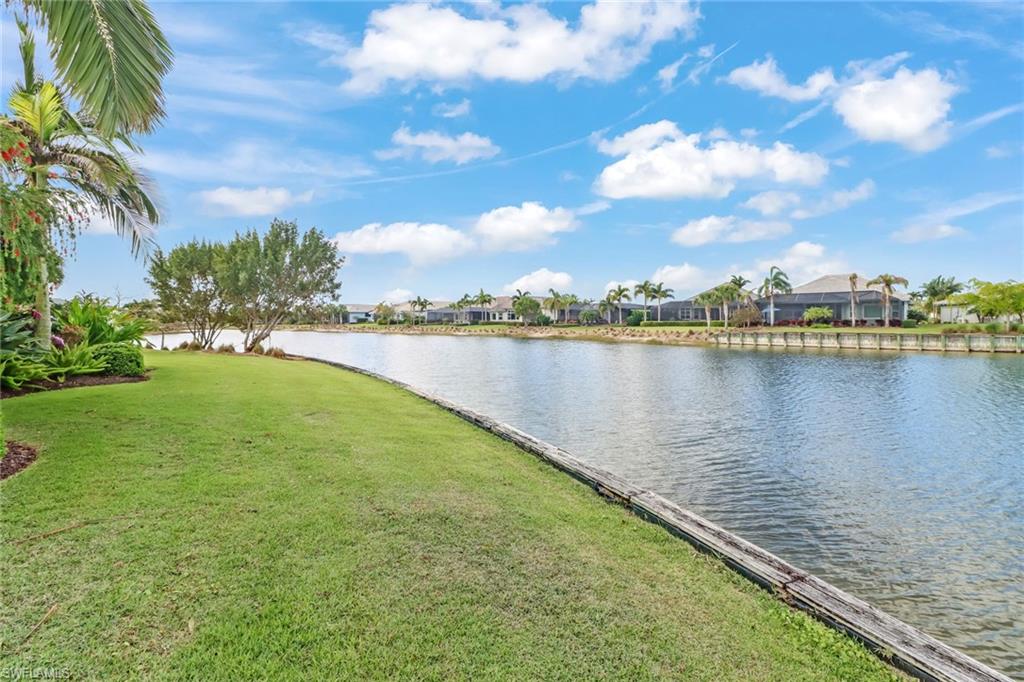 6487 Warwick Avenue Naples, FL 34113 - Photo 32 of 32 a view of a lake with houses in the back