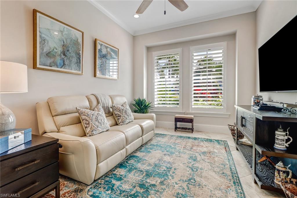 6487 Warwick Avenue Naples, FL 34113 - Photo 4 of 32 a living room with furniture and a flat screen tv