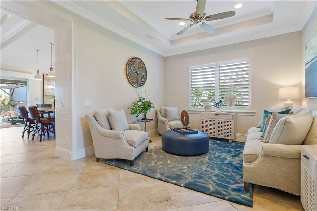 6487 Warwick Avenue Naples, FL 34113 - Photo 7 of 32 a living room with furniture and a large window