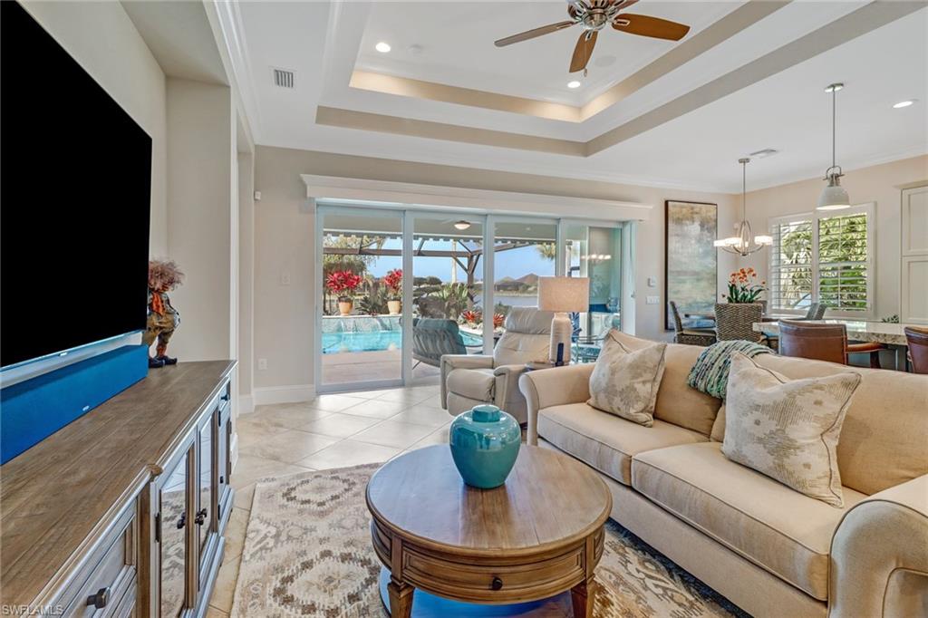6487 Warwick Avenue Naples, FL 34113 - Photo 9 of 32 a living room with furniture and a flat screen tv