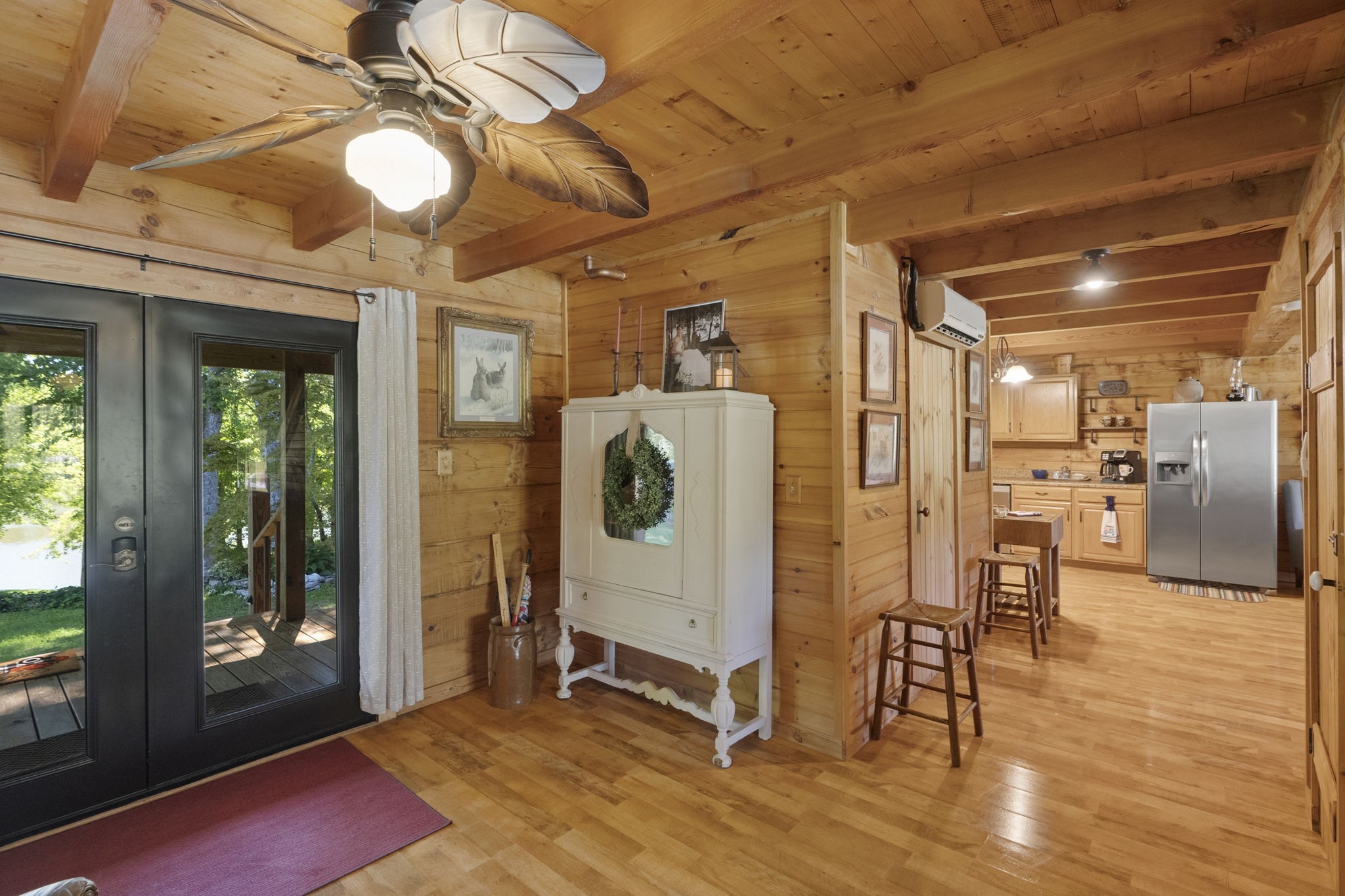 546 Hiwassee Road Lebanon, TN 37087 - Photo 32 of 67 a view of a hallway with wooden floor windows a chandelier and fireplace