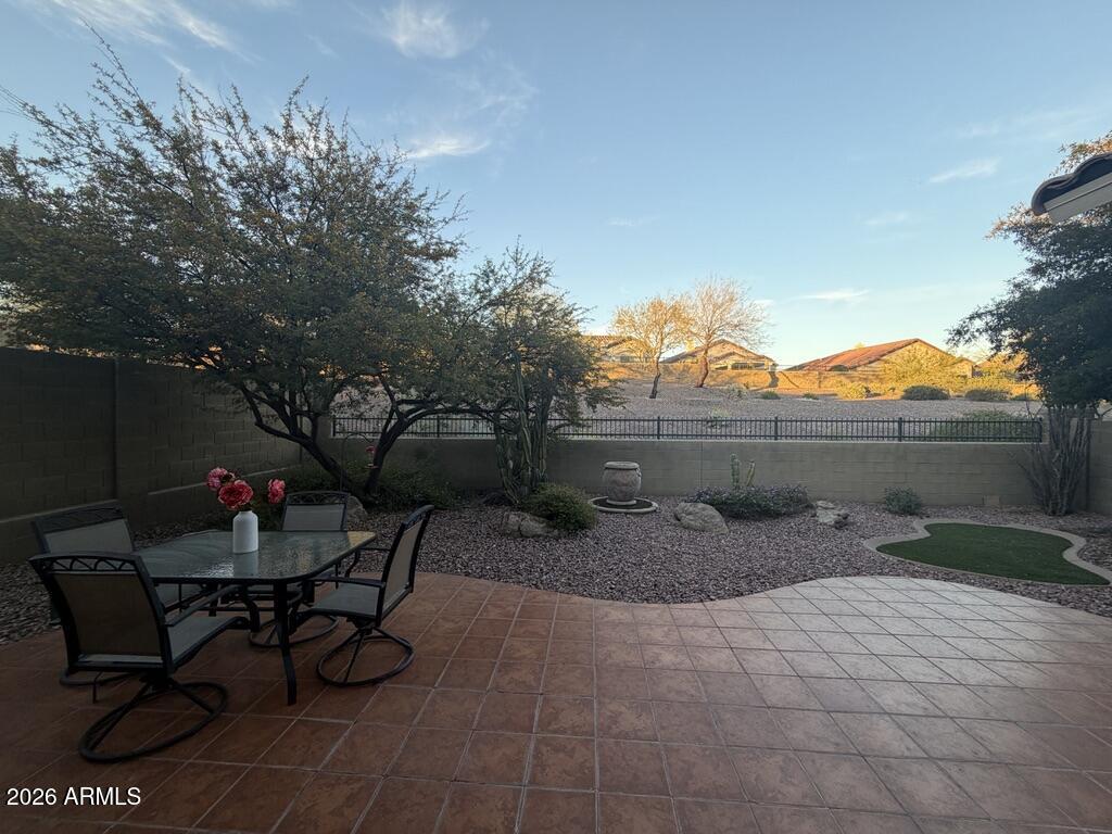 3330 West Ravina Lane Anthem, AZ 85086 - Photo 14 of 29 a backyard of a house with table and chairs