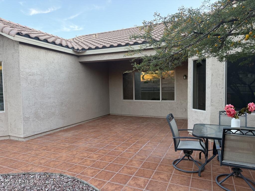 3330 West Ravina Lane Anthem, AZ 85086 - Photo 16 of 29 a view of a patio with table and chairs and potted plants