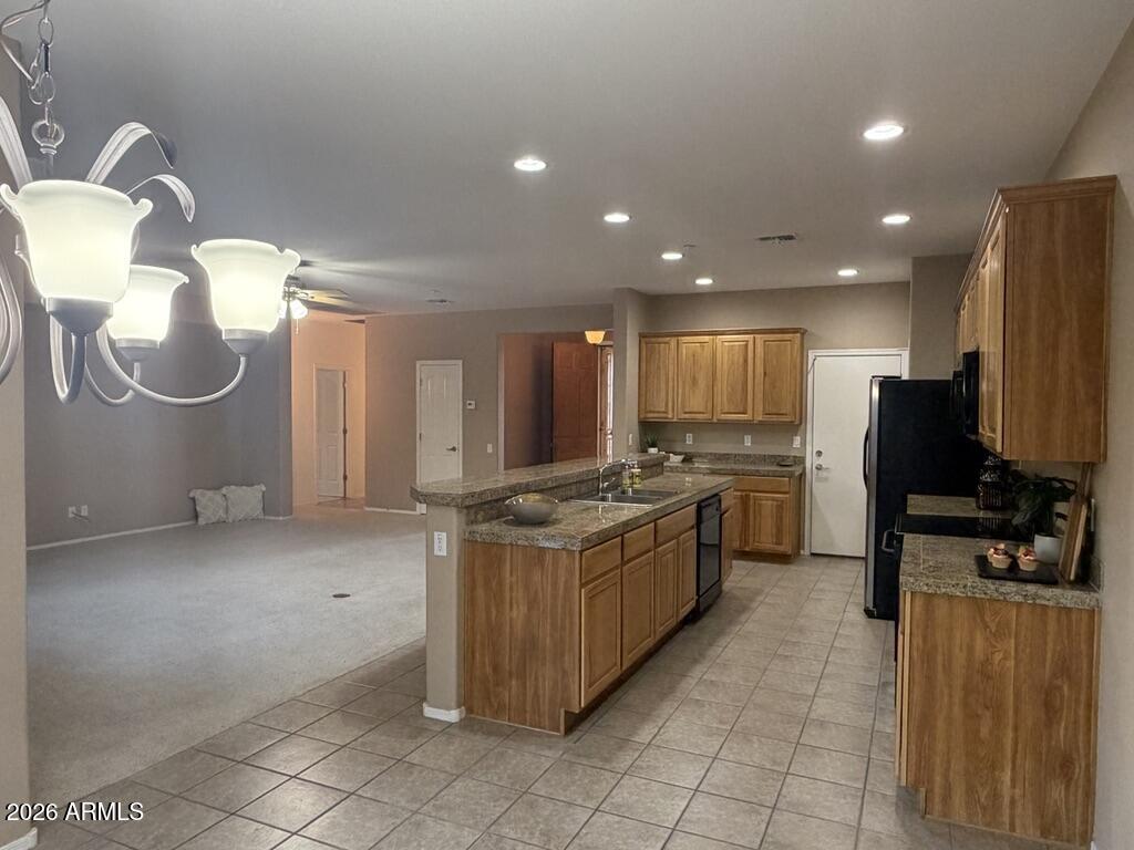 3330 West Ravina Lane Anthem, AZ 85086 - Photo 5 of 29 a kitchen with stainless steel appliances granite countertop a stove a sink and a refrigerator