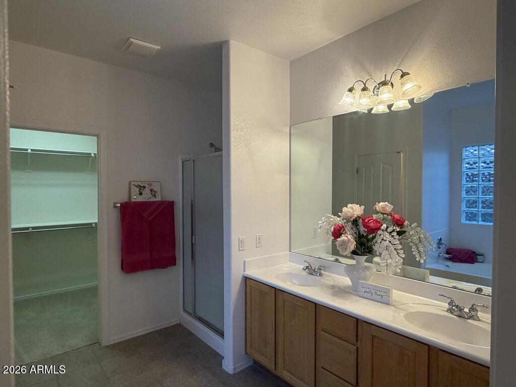 3330 West Ravina Lane Anthem, AZ 85086 - Photo 9 of 29 a bathroom with a double vanity sink and a mirror