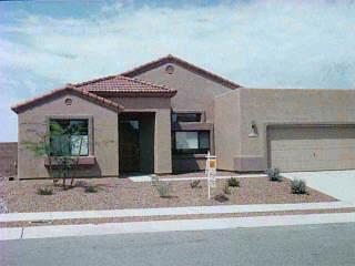 1062 South Riparian Avenue Tucson, AZ 85748 - Photo 1 of 1 a view of a brick house with large windows