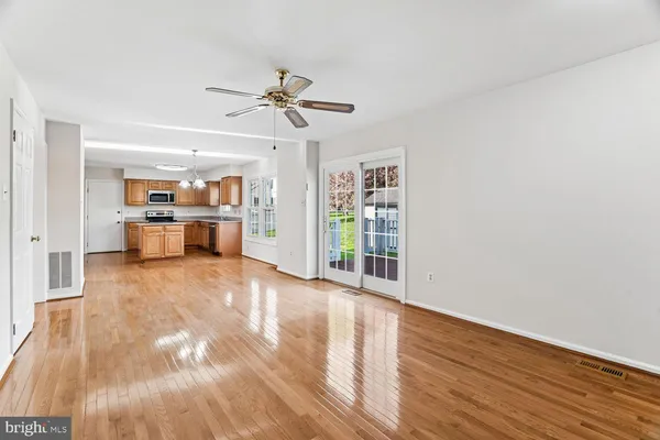 a big room with wooden floor and windows