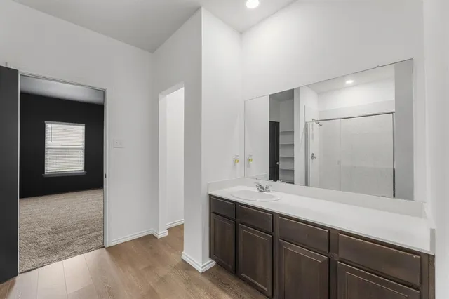 a bathroom with a glass shower door