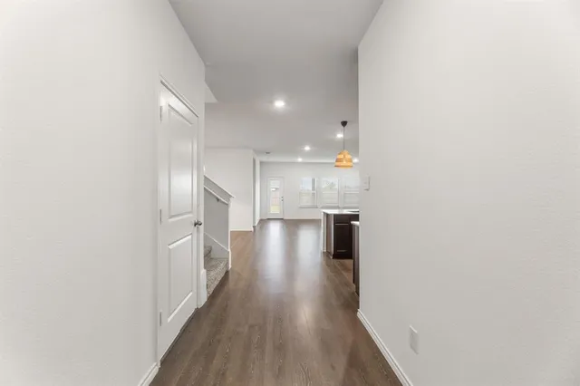 a view of a hallway with wooden floor