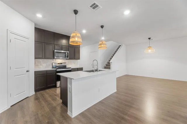 a kitchen with a sink cabinets and window