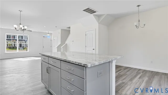 a kitchen with a granite countertop sink and dishwasher