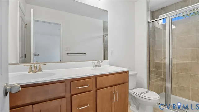 a bathroom with a sink toilet vanity and shower