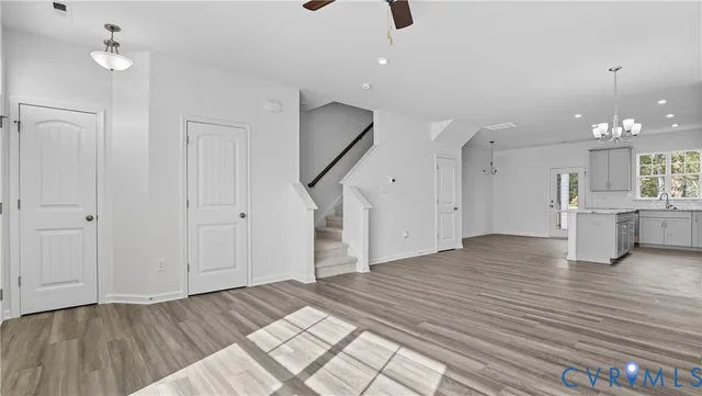 a view of a room with wooden floor and staircase