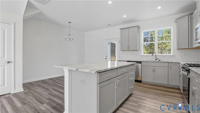 a kitchen with a sink stove and cabinets