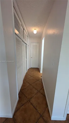 a bathroom with a granite countertop sink mirror vanity and toilet