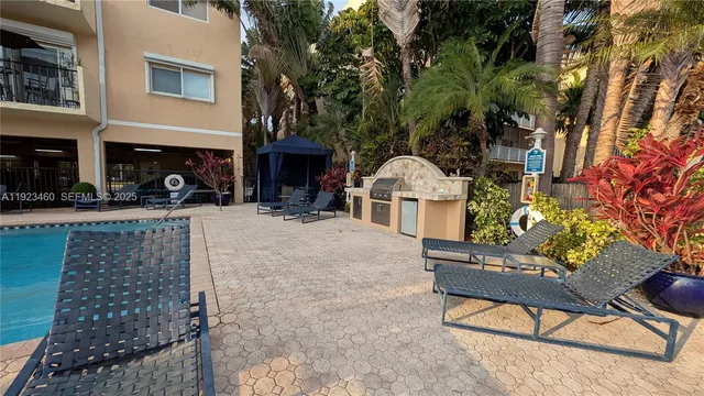 a view of a patio with table and chairs and potted plants
