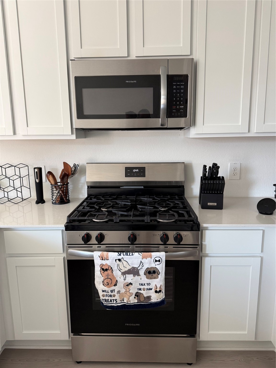 16722 Largetooth Aspen Lane New Caney, TX 77357 - Photo 24 of 37 a kitchen with stainless steel appliances granite countertop a stove and a microwave