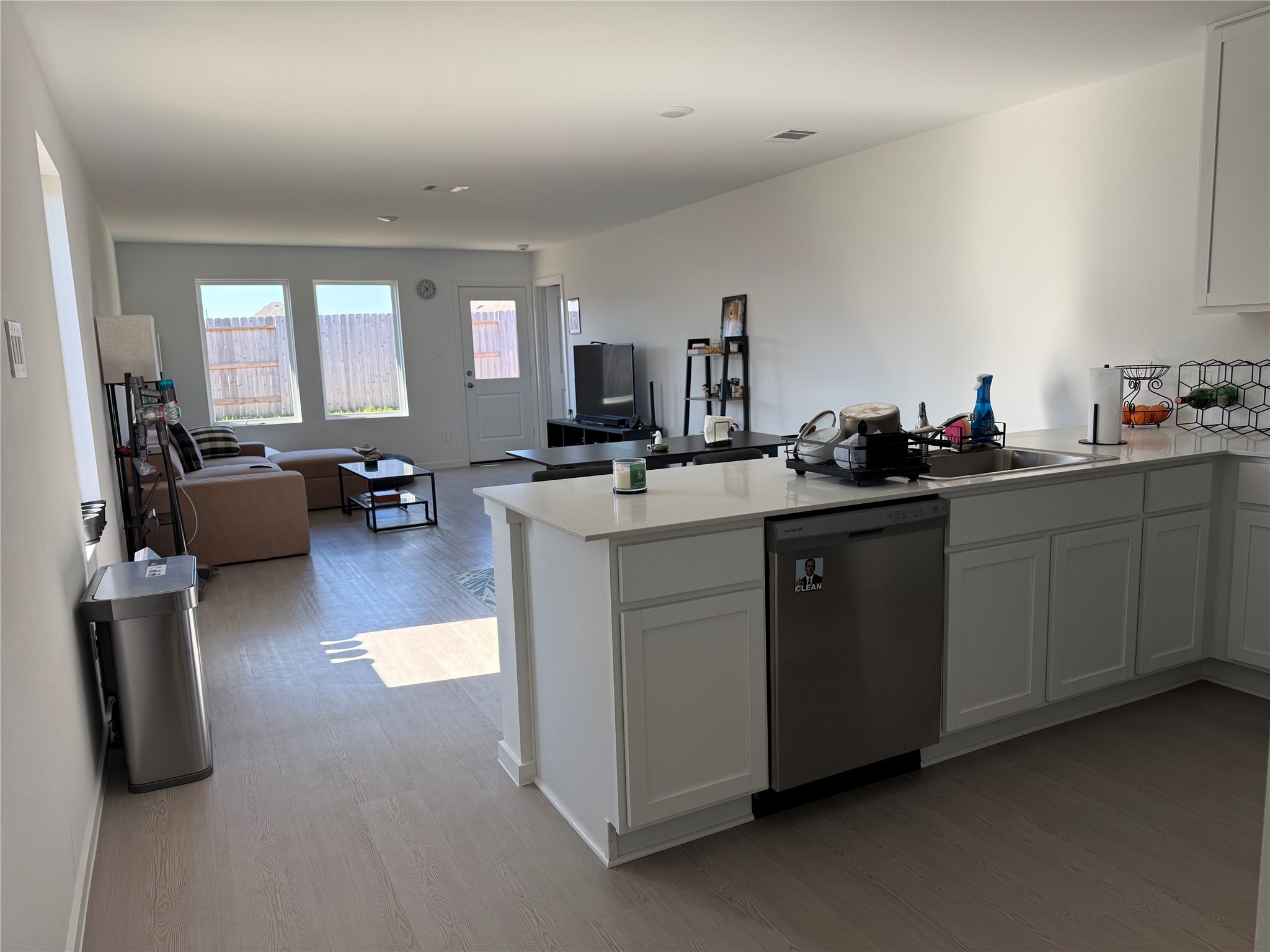 16722 Largetooth Aspen Lane New Caney, TX 77357 - Photo 25 of 37 a kitchen with sink cabinets and living room view