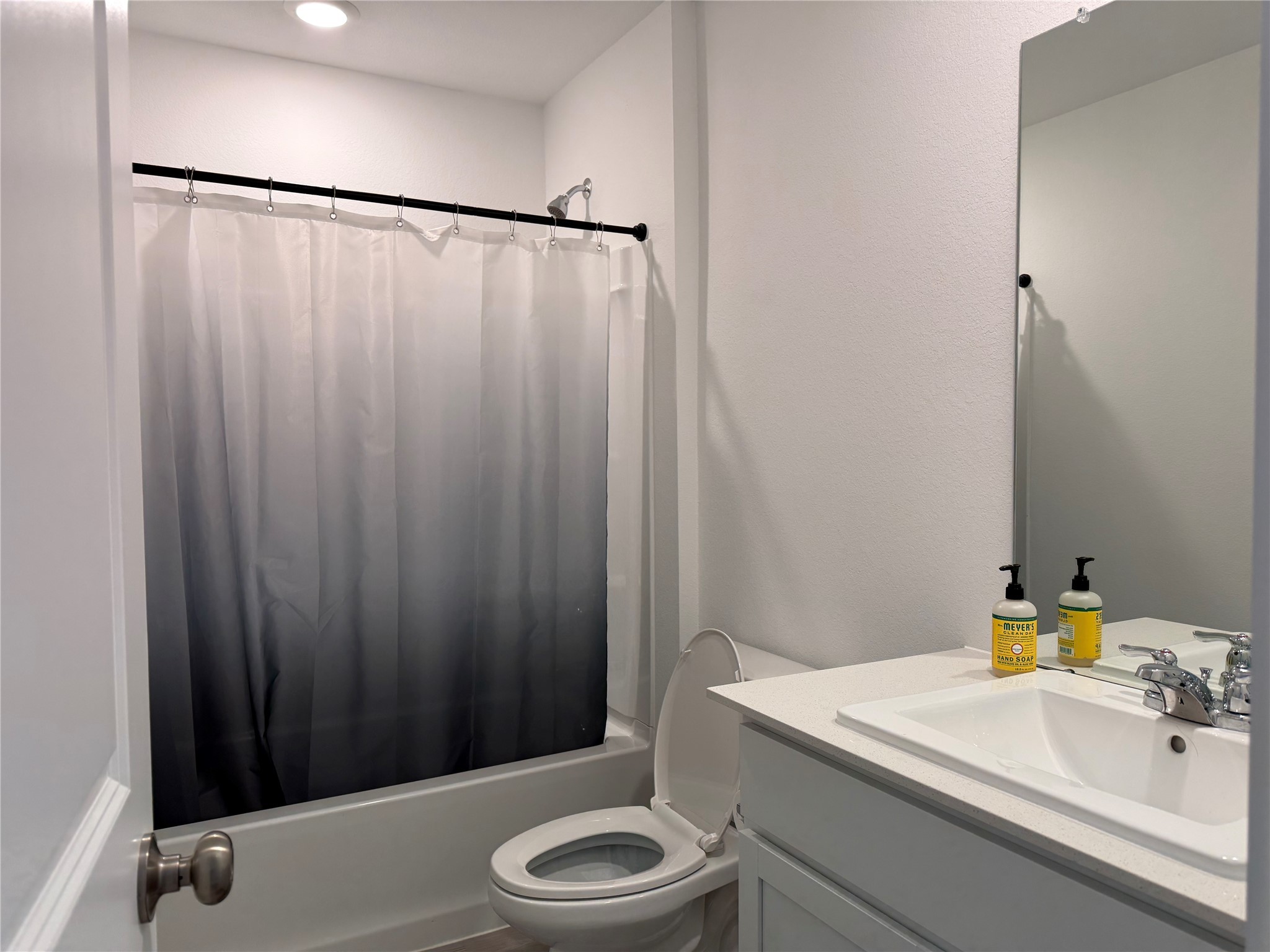 16722 Largetooth Aspen Lane New Caney, TX 77357 - Photo 31 of 37 a bathroom with a sink a toilet and shower curtain