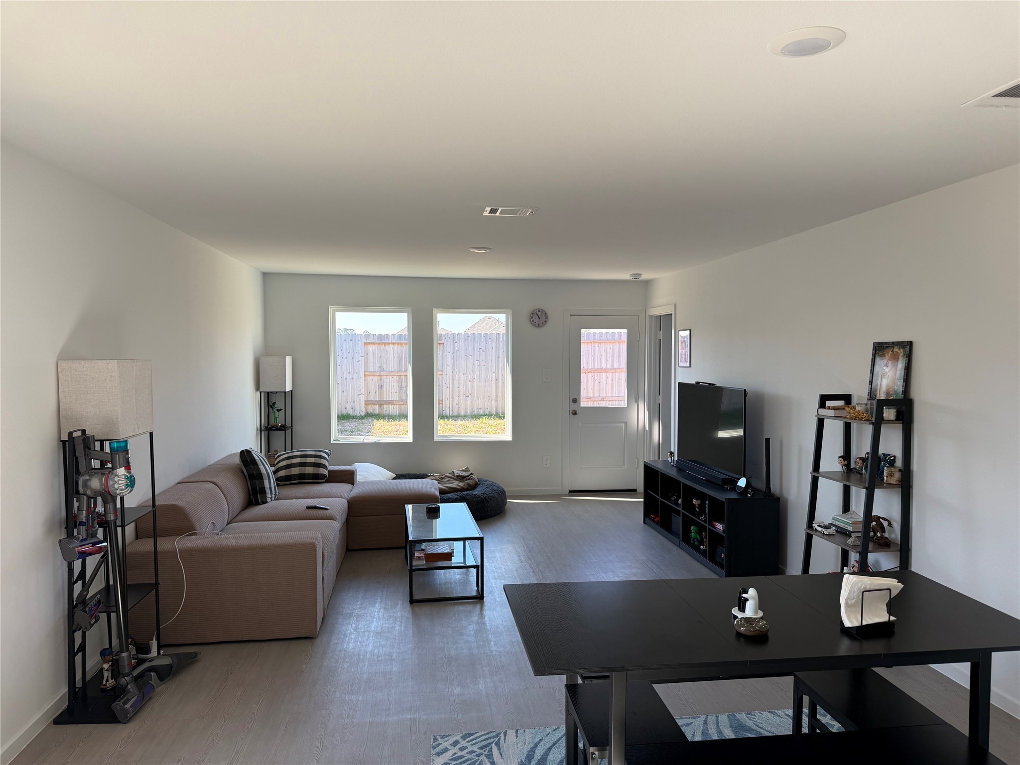 16722 Largetooth Aspen Lane New Caney, TX 77357 - Photo 6 of 37 a living room with furniture a flat screen tv and a window