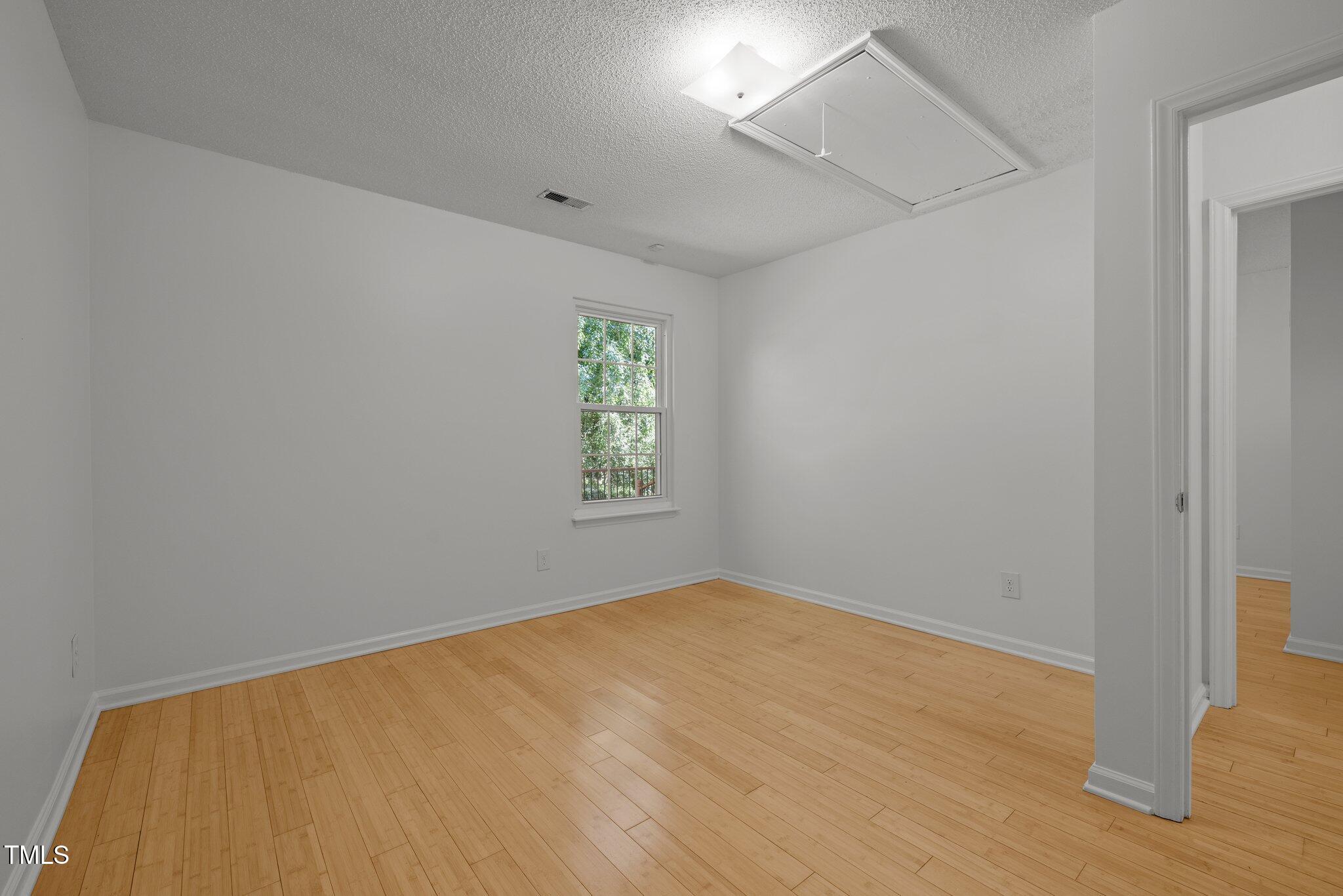 1040 Mills Street Raleigh, NC 27608 - Photo 11 of 21 an empty room with a window