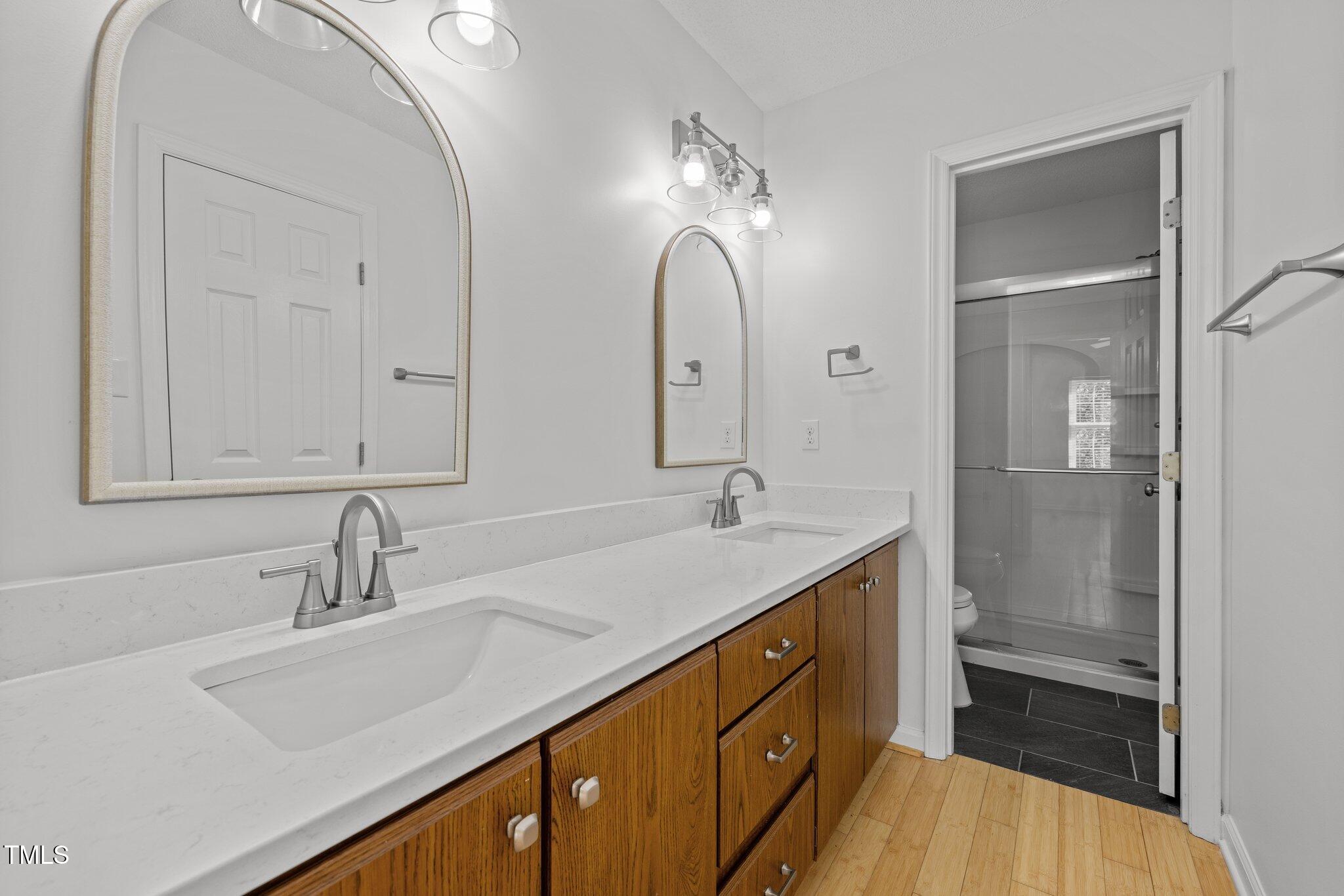 1040 Mills Street Raleigh, NC 27608 - Photo 17 of 21 a bathroom with a sink double vanity and a mirror