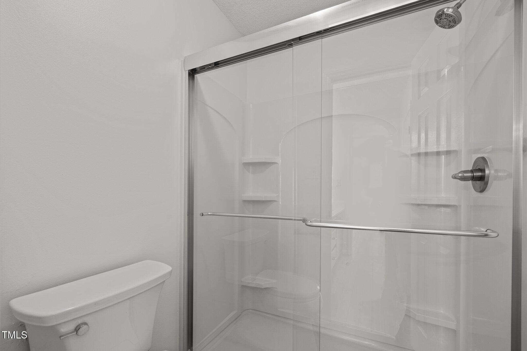 1040 Mills Street Raleigh, NC 27608 - Photo 19 of 21 a bathroom with a toilet and a shower