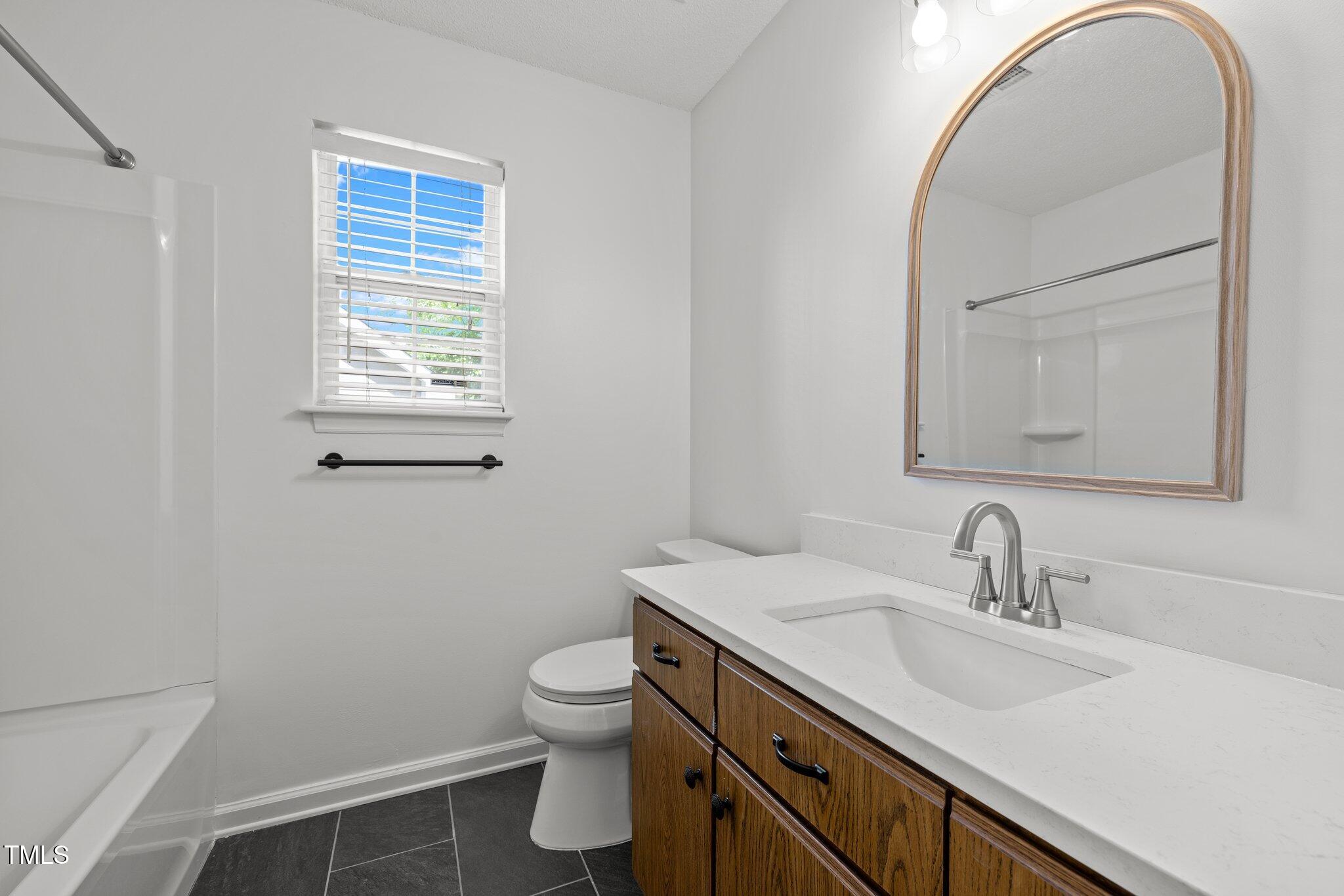 1040 Mills Street Raleigh, NC 27608 - Photo 9 of 21 a bathroom with a sink and a mirror