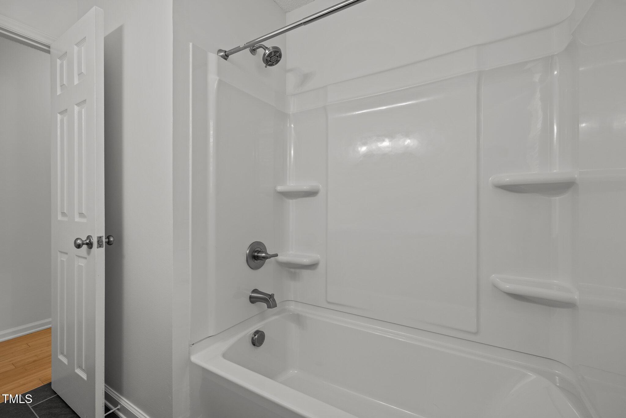 1040 Mills Street Raleigh, NC 27608 - Photo 10 of 21 a bathroom with a bathtub and a shower