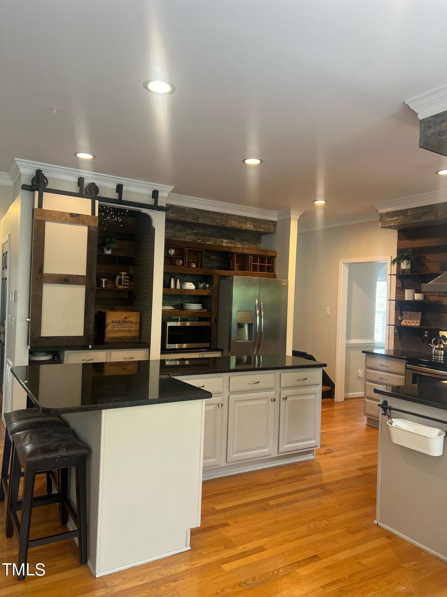 107 Whitney Lane Durham, NC 27713 - Photo 15 of 42 a kitchen with stainless steel appliances kitchen island granite countertop a refrigerator and a stove top oven