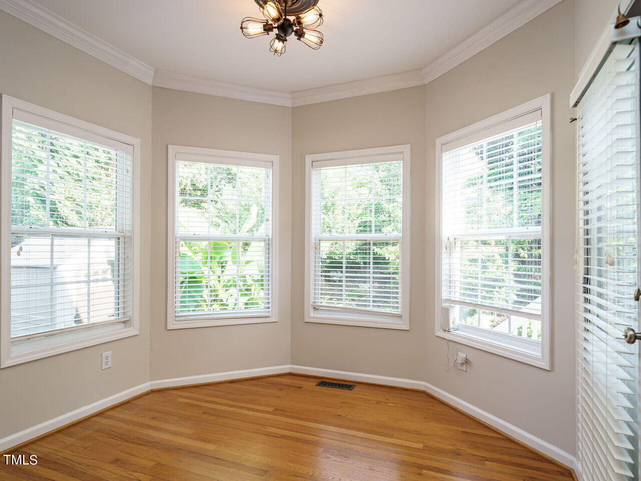 107 Whitney Lane Durham, NC 27713 - Photo 16 of 42 a view of an empty room with a window and wooden floor
