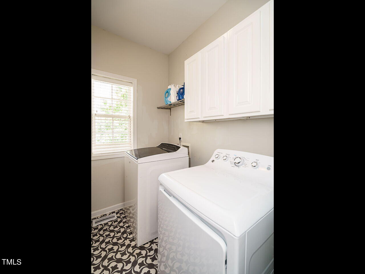 107 Whitney Lane Durham, NC 27713 - Photo 24 of 42 a view of washer and dryer with bathroom in the background