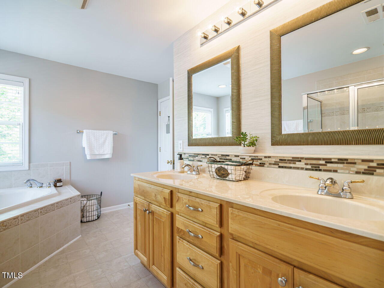107 Whitney Lane Durham, NC 27713 - Photo 28 of 42 a bathroom with a double vanity sink mirror and a