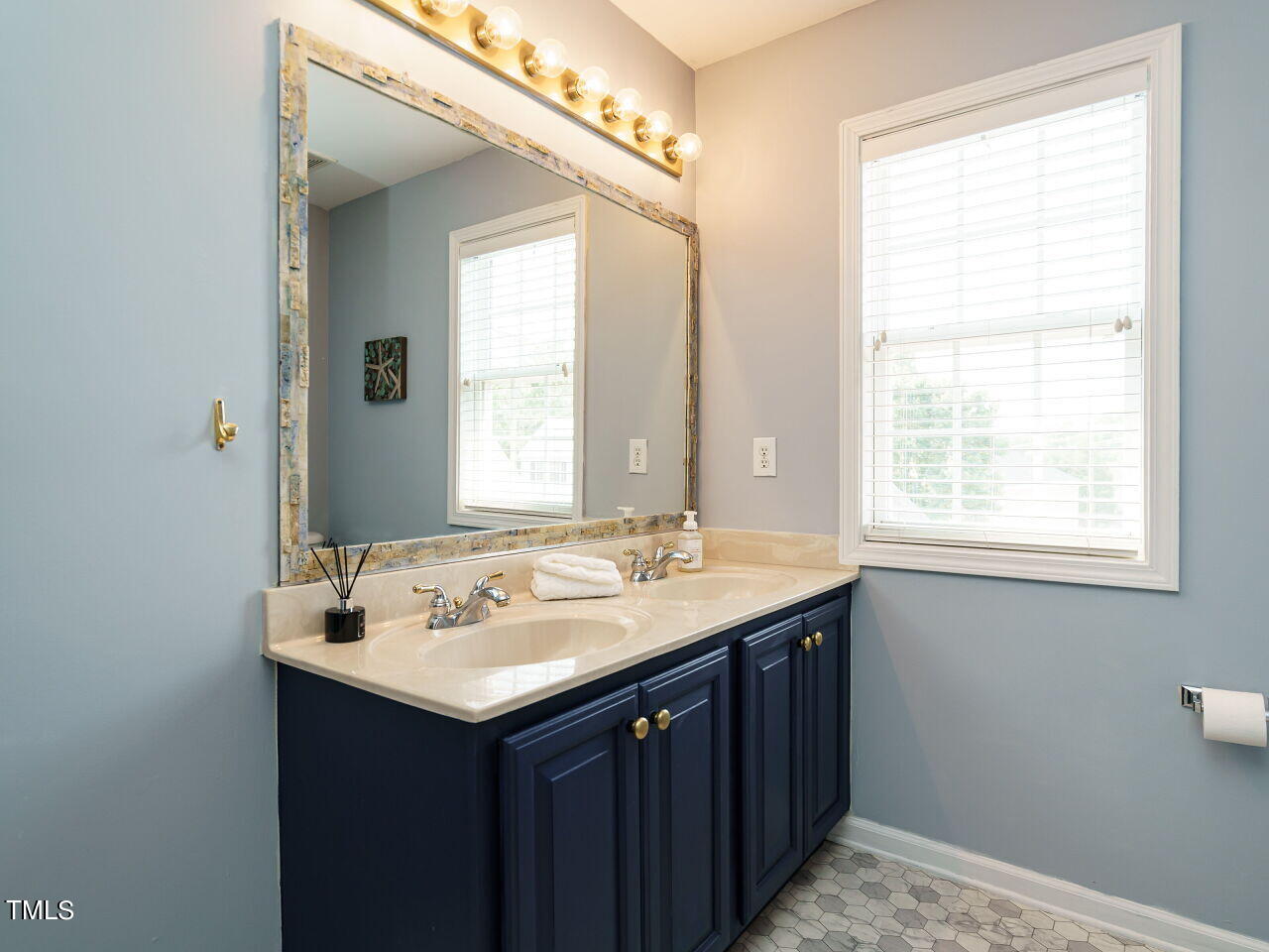107 Whitney Lane Durham, NC 27713 - Photo 33 of 42 a bathroom with a sink and a mirror