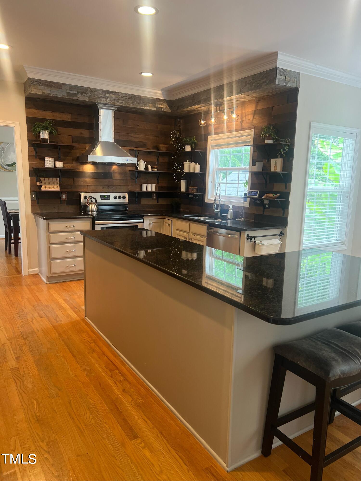 107 Whitney Lane Durham, NC 27713 - Photo 41 of 42 a kitchen with stainless steel appliances granite countertop a stove and a refrigerator