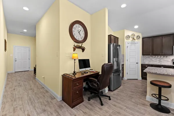 a view of a workspace with furniture and wooden floor