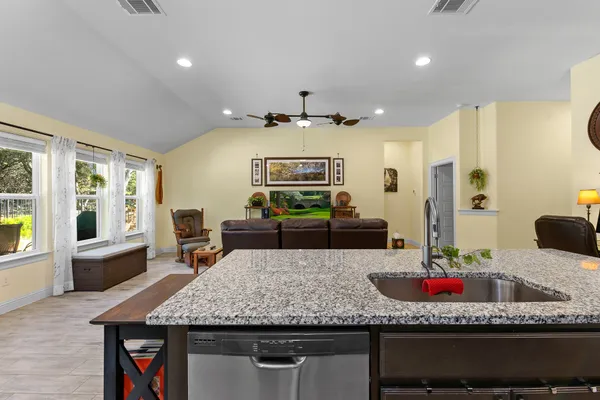 a kitchen with stainless steel appliances granite countertop a stove and cabinets